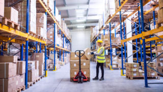 Female warehouse worker loading boxes.