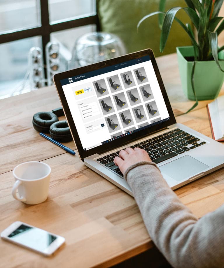 Woman working on laptop with white screen in modern office.